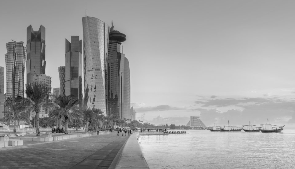 Black-and-white view of the Doha Corniche and West Bay towers